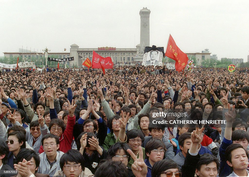 Students gesture and shout slogans as they pay res