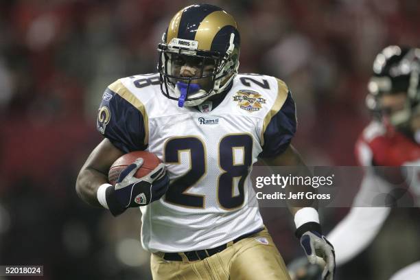 Marshall Faulk of the St. Louis Rams runs against the Atlanta Falcons during the NFC Divisional Playoff game at the Georgia Dome on January 15, 2005...