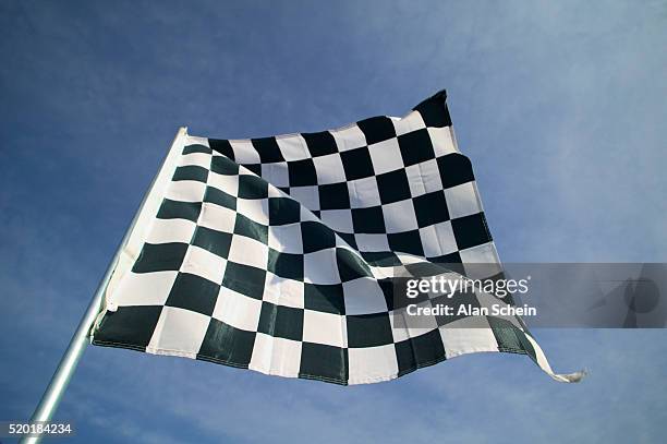 checkered flag against sky - checkered-flag-finish-line stock pictures, royalty-free photos & images