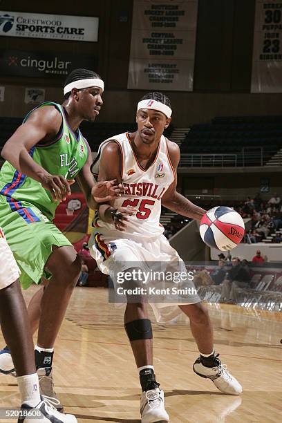 Damone Brown of the Huntsville Flight dribbles the ball against Hiram Fuller of the Florida Flame during an NBDL game on December 11, 2004 at the Von...