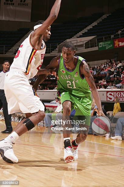 Darius Rice of the Florida Flame dribbles the ball against Damone Brown of the Huntsville Flight during an NBDL game on December 11, 2004 at the Von...
