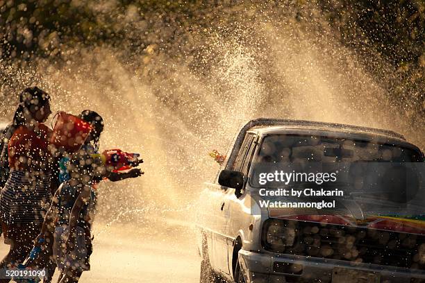 water battle (songkran festival in chanthaburi) - songkran stock pictures, royalty-free photos & images