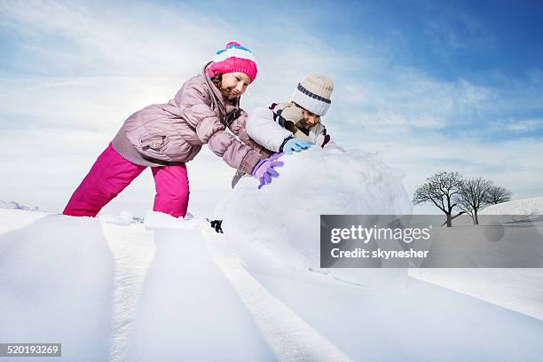 children playing in snow. - roll up stock pictures, royalty-free photos & images