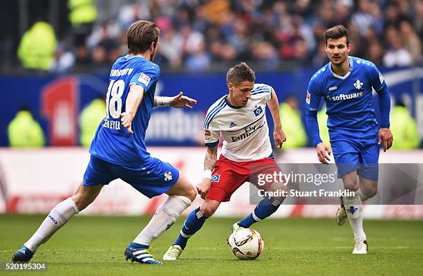 Ivo Ilicevic of Hamburg is challenged by Peter Niemeyer of Darmstadt during the Bundesliga match between Hamburger SV and SV Darmstadt 98 at...