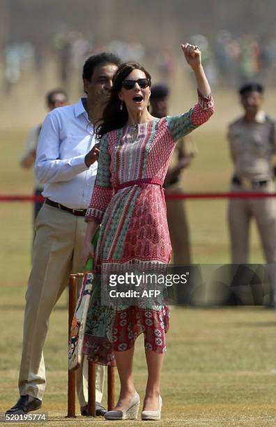 Former Indian cricketer Dilip Vengsarkarlooks on as Catherine, Duchess of Cambridge and an unseen Britain's Prince William, Duke of Cambridge play a...