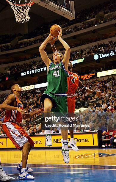 Forward Dirk Nowitzki the Dallas Mavericks goes to the hoop against Antawn Jamison of the Washington Wizards on January 18, 2005 at the American...