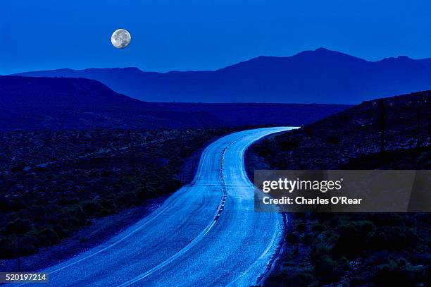 moon rising above highway 190 - death valley road bildbanksfoton och bilder