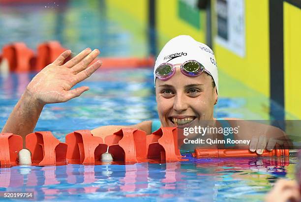 Alicia Coutts of Australia waves to the crowd after winning in the Women's 200 Metre Individual Medley during day four of the Australian Swimming...