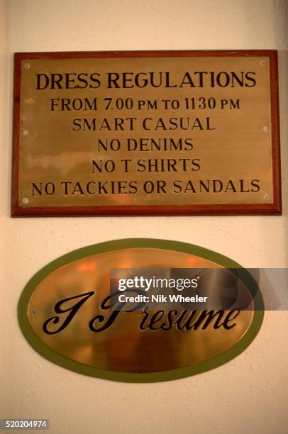 Brass plaques at the Victoria Falls Hotel inform guests of the hotel's evening "smart casual" dress code and refer to explorer David Livingstone with...