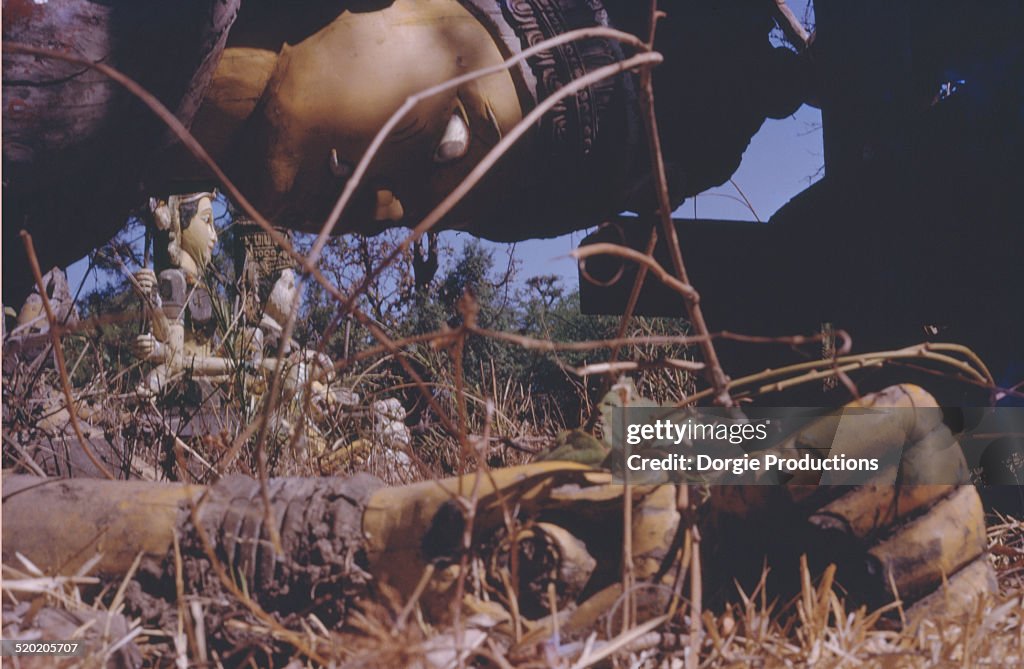 Decaying Gods in a field once used in processions