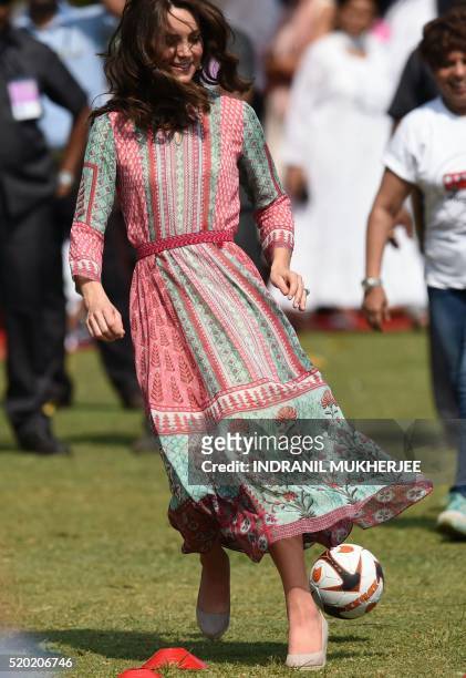 Britain's Catherine, Duchess of Cambridge, plays with Indian children at the Oval Maidan in Mumbai on April 10, 2016.