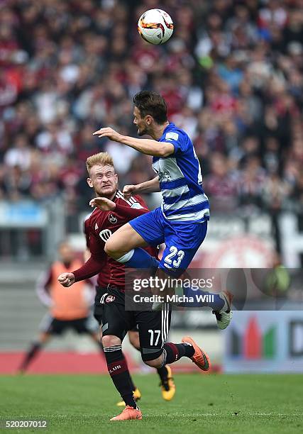 Sebastian Kerk of Nuernberg and James Holland of Duisburg compete for the ball during the Second Bundesliga match between 1. FC Nuernberg and MSV...