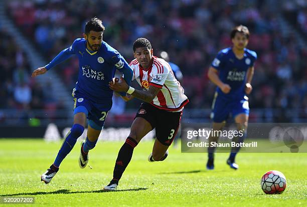 Riyad Mahrez of Leicester City and Patrick van Aanholt of Sunderland chase the ball during the Barclays Premier League match between Sunderland and...