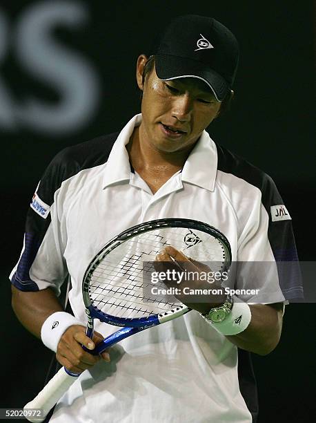 Takao Suzuki of Japan looks dejected during his match against Roger Federer of Switzerland during day three of the Australian Open Grand Slam at...