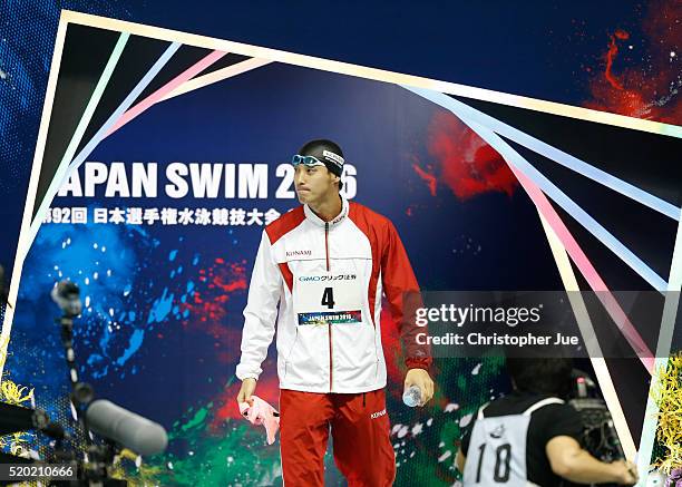 Takuro Fujii enters the pool area to compete in the men's 100m butterfly final at the Japan Swim 2016 at Tokyo Tatsumi International Swimming Pool on...