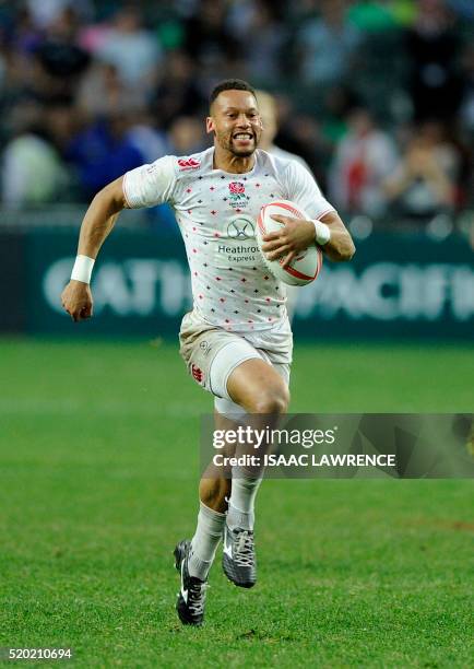 Dan Norton of England runs in a try against the United States during the Plate Final on the third day of the Hong Kong Rugby Sevens tournament on...