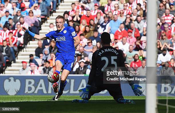 Jamie Vardy of Leicester City shoots past goalkeeper Vito Mannone of Sunderland as he scores their first goal during the Barclays Premier League...