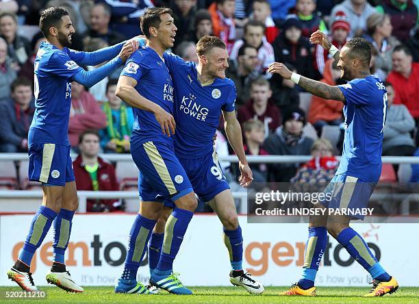 Leicester City's English striker Jamie Vardy celebrates scoring his team's first goal with Leicester City's Argentinian striker Leonardo Ulloa , and...