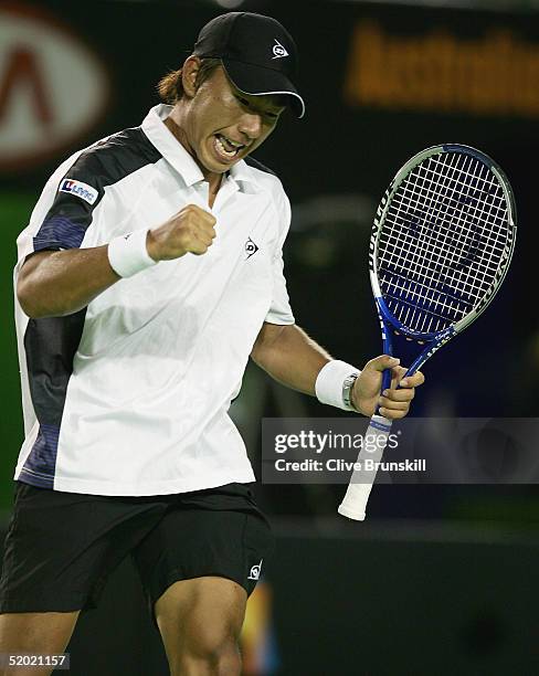 Takao Suzuki of Japan celebrates a point against Roger Federer of Switzerland during day three of the Australian Open Grand Slam at Melbourne Park...