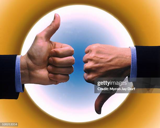 thumbs-up and thumbs-down - pessimisme stock pictures, royalty-free photos & images