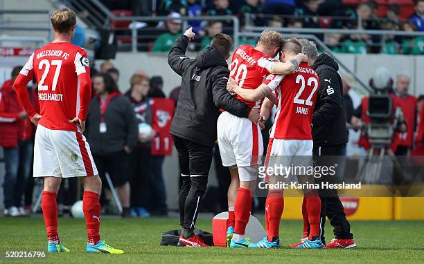 Soeren Bertram of Halle is brought from the pitch after an injury during the Third League match between Hallescher FC and Chemnitzer FC at Erdgas...