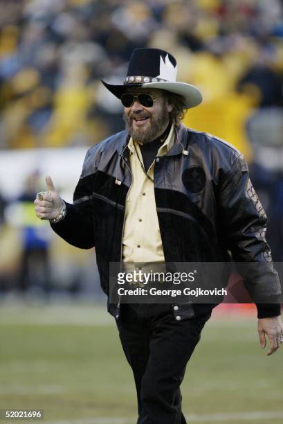 Hank Williams, Jr., gestures to the crowd after singing the national anthem at the Pittsburgh Steelers and New York Jets AFC playoff game at Heinz...