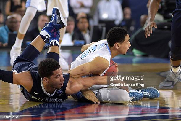 Marcus Paige of the North Carolina Tar Heels regains control of the ball against Josh Hart of the Villanova Wildcats during the 2016 NCAA Men's Final...