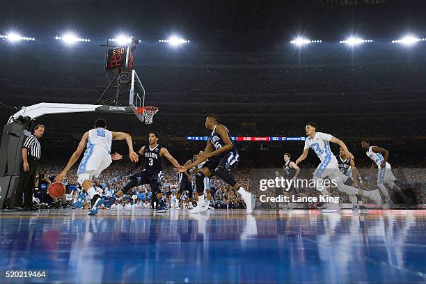 Marcus Paige of the North Carolina Tar Heels moves the ball against Josh Hart of the Villanova Wildcats during the 2016 NCAA Men's Final Four...