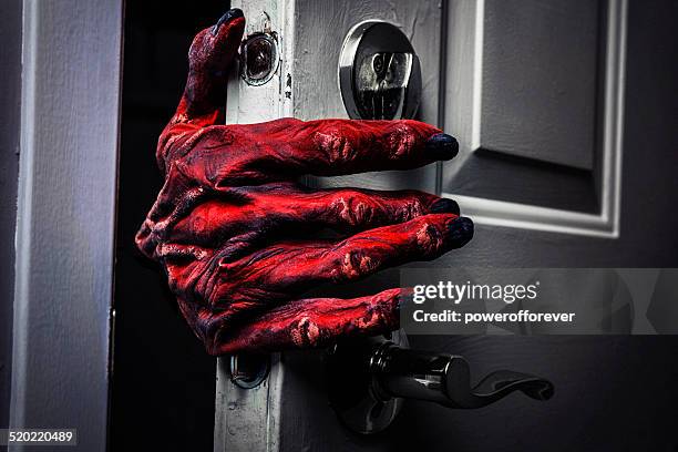 monster's hand comming in the door - halloween scary stockfoto's en -beelden
