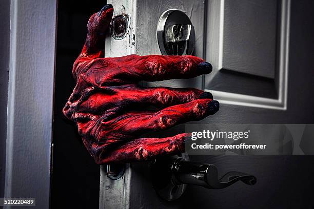 monster's hand comming in the door - zombie hand stock pictures, royalty-free photos & images