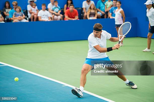 professional tennis player in action - male athlete stock pictures, royalty-free photos & images