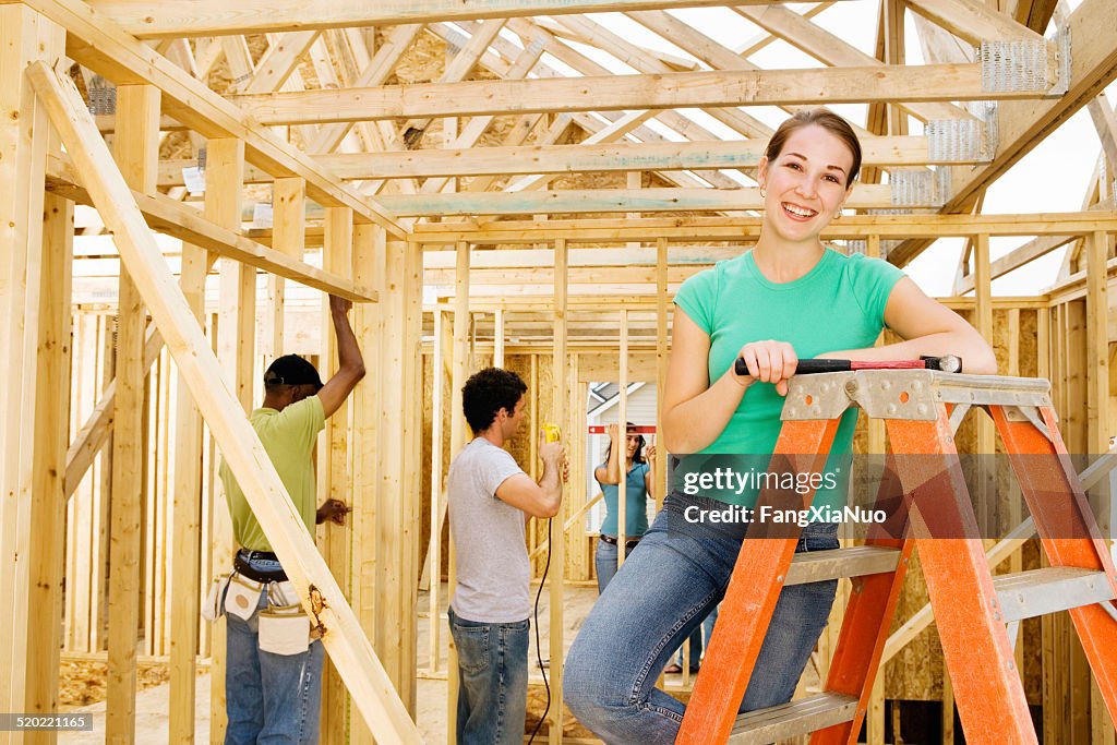 Female volunteer at home construction site, portrait