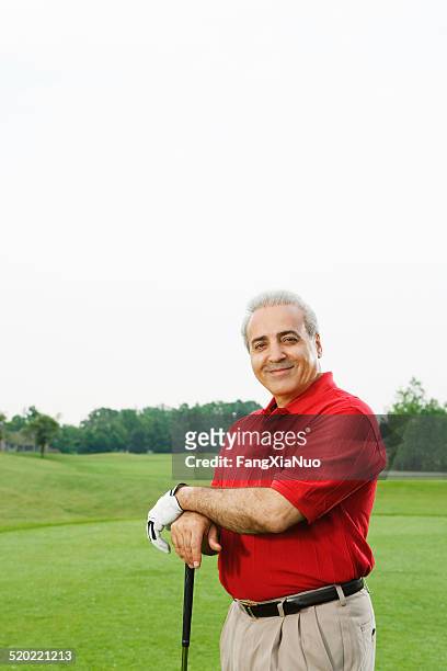 golfer smiling on golf course - golf short iron stock pictures, royalty-free photos & images