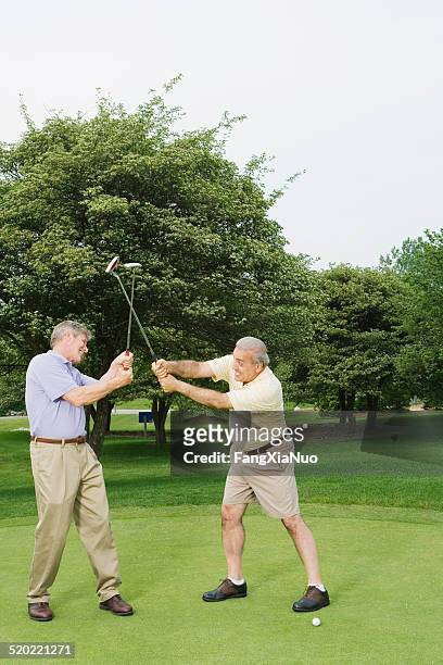 two men fighting with golf club - golf short iron stock pictures, royalty-free photos & images