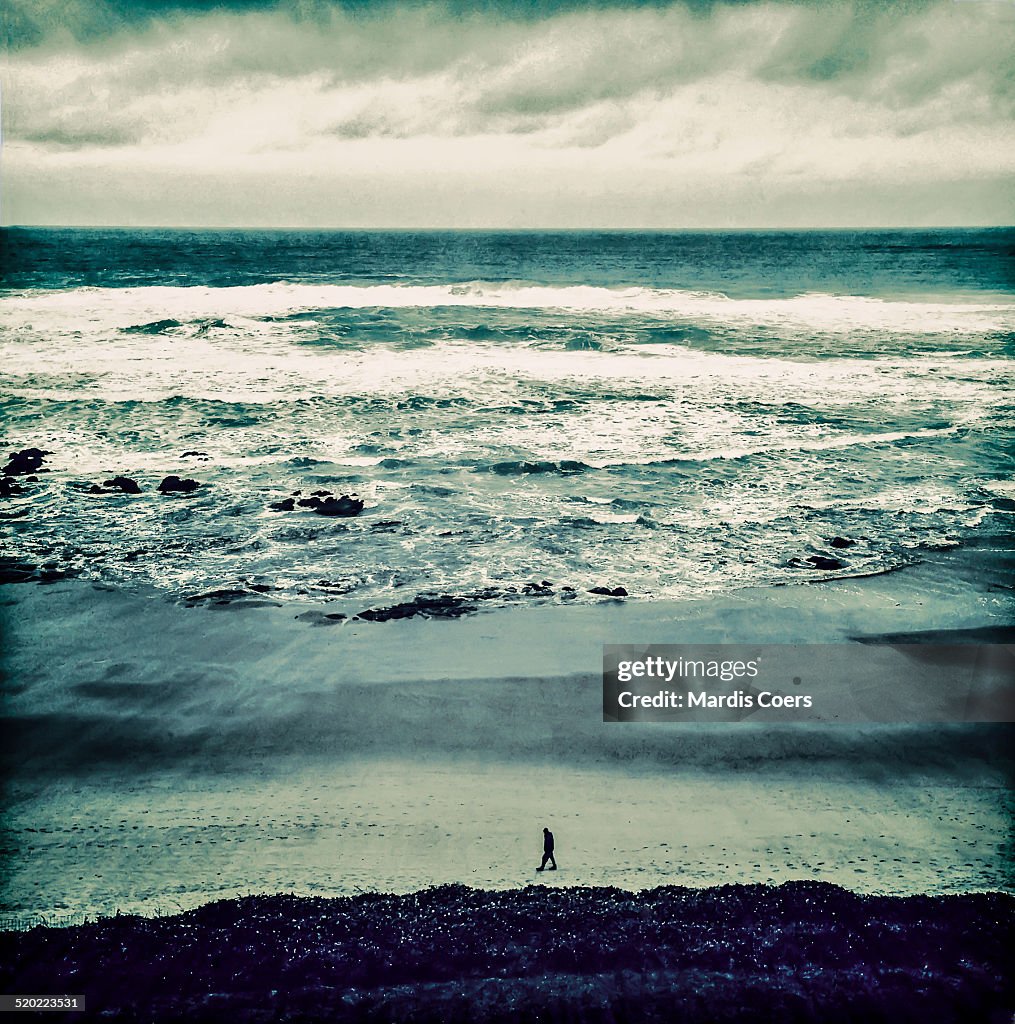 Solitary man on Oregon beach.