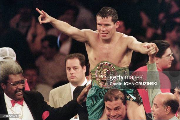Super lightweight champion Julio Cesar Chavez of Mexico celebrates after he retained his title with a unanimous 12-round decision over Giovanni...
