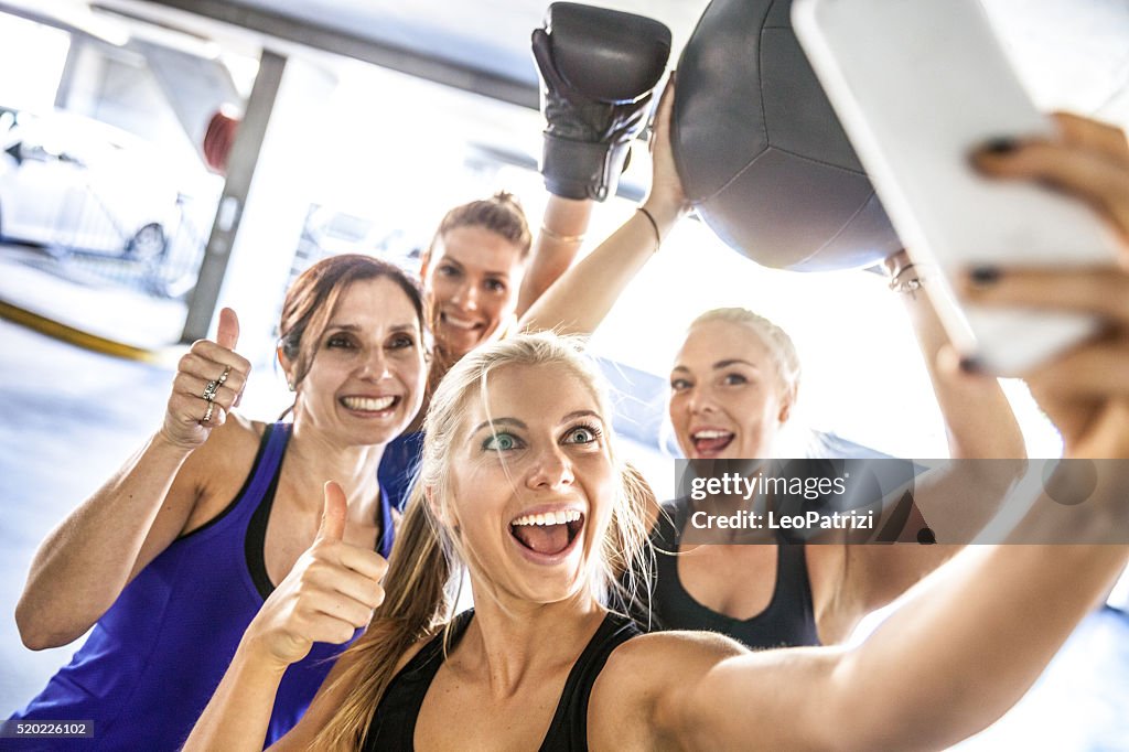 Fitness friends having a break with selfie post workout
