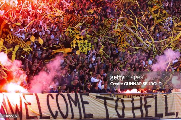 Solna fans display a banner reading "Welcome To Hell" as they wave flags and cheer in the stands of Rasunda stadium in Stockholm during the Champions...
