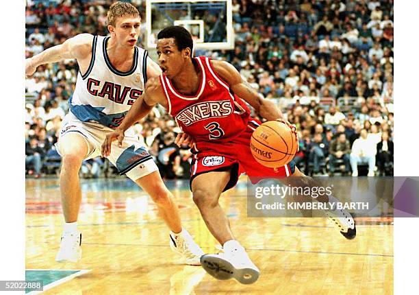 Philadelphia 76ers' rookie guard Allen Iverson drives for the basket against Cleveland Cavaliers guard Bobby Sura in game action,12 April in...