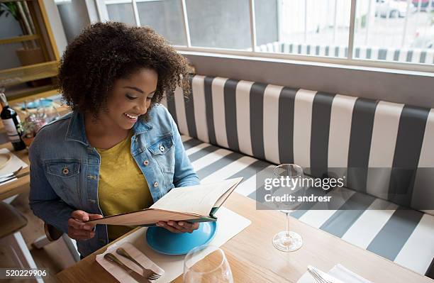 black woman eating at a restaurant - cafeteria menu stock pictures, royalty-free photos & images