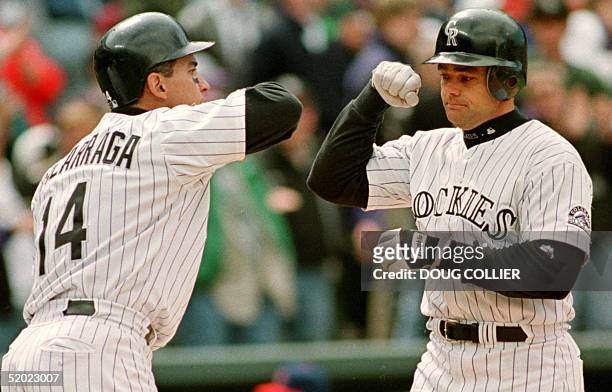Colorado Rockies Dante Bichette is congratulated by Andres Galarraga after Bichette hit a two run home run in the sixth inning of their game 01 May...
