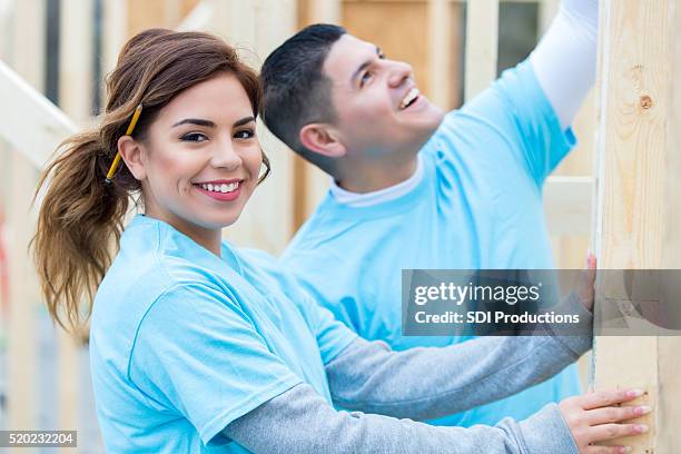 couple build house together for charity - habitat for humanity stock pictures, royalty-free photos & images