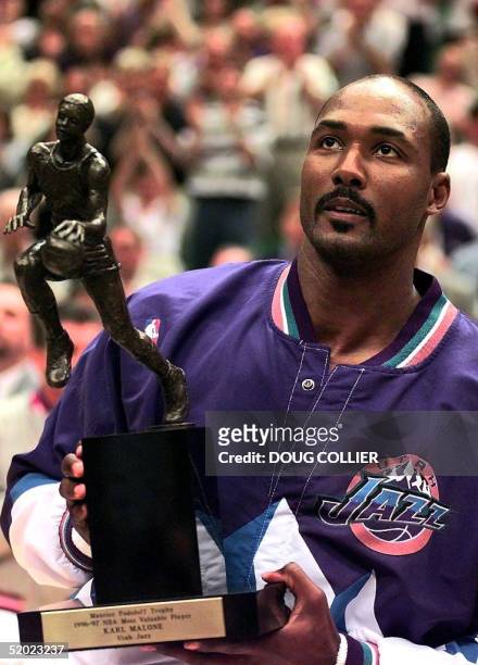 Karl Malone of the Utah Jazz holds the Maurice Podoloff Trophy for being named the NBA's Most Valuable PLayer 19 May before game one of the Western...