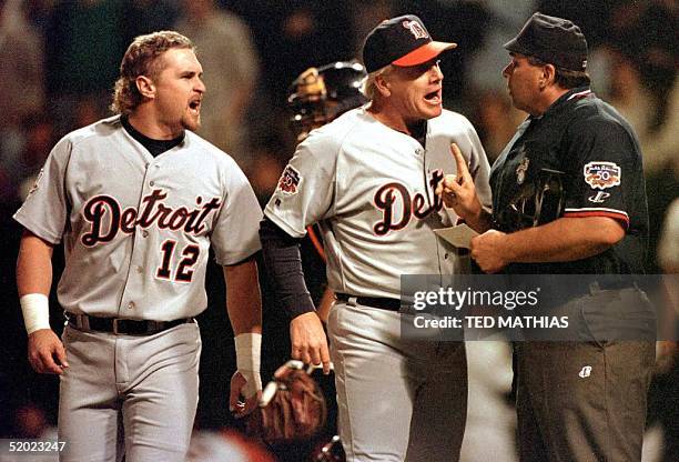 Detroit Tigers pinch hitter Phil Nevin and coach Bobby Bell argue Nevin's ejection from the game with home plate umpire Greg Kosc after Nevin struck...