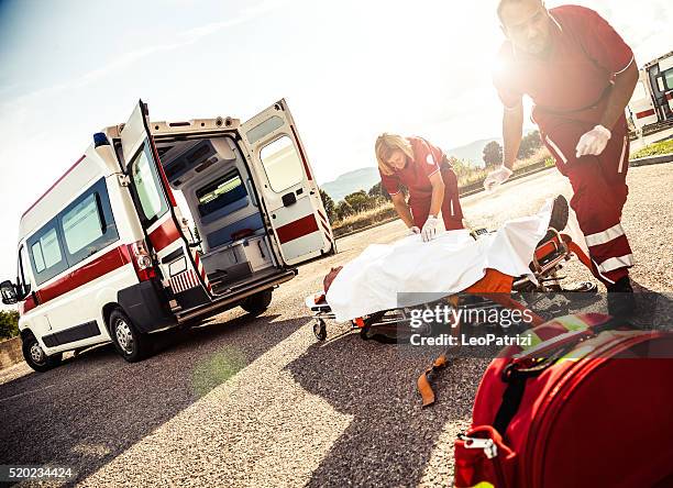 emt team provide first aid on the street - injured street stockfoto's en -beelden