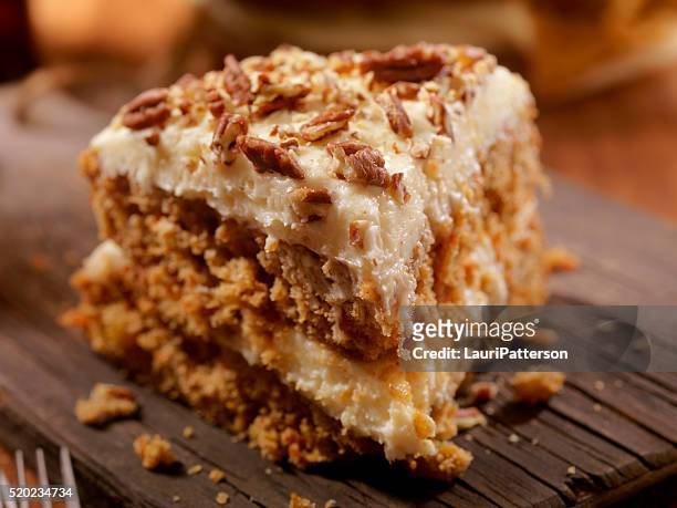carrot cake with cream cheese icing - pecan nut stock pictures, royalty-free photos & images