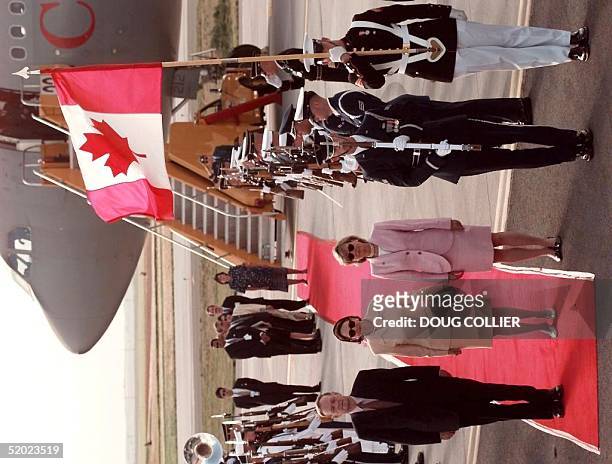 Canadian Prime Minister Jean Chretien and his wife Aline stand at attention as the Canadian National Anthem plays on their arrival at Denver...