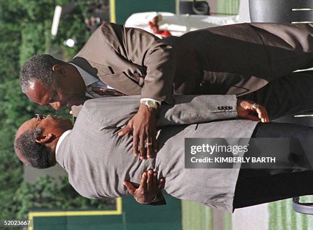 Baseball legend Henry "Hank" Aaron hugs Cleveland Indians baseball great Larry Doby during a ceremony in Doby's honor before the Indians played the...