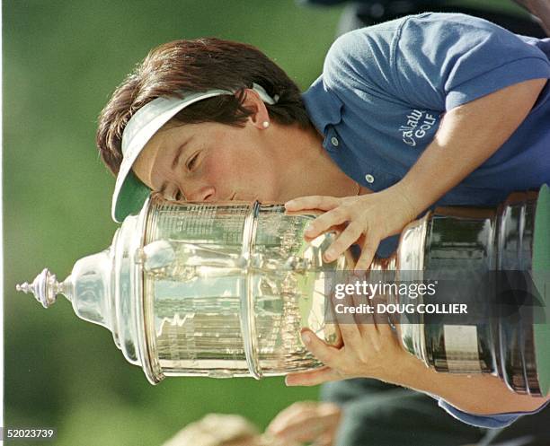 Alison Nicholas of England kisses her trophy after shooting a 10-under-par to win the 1997 US Women's Open Championship at Pumpkin Ridge Golf Club in...