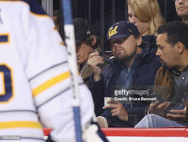 Leonardo DiCaprio watches the game between the New York Islanders and the Buffalo Sabres at the Barclays Center on April 9, 2016 in the Brooklyn...